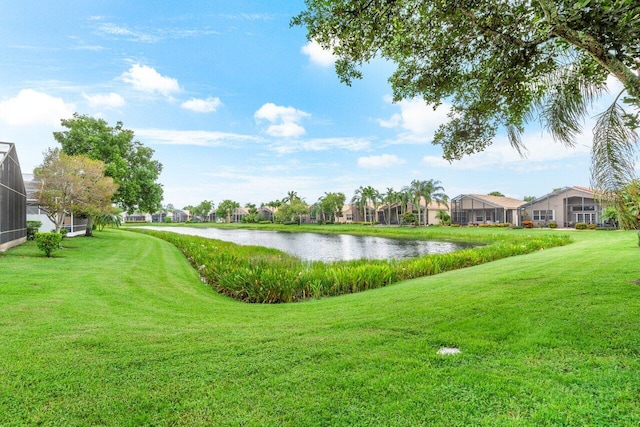 view of community with a yard and a water view