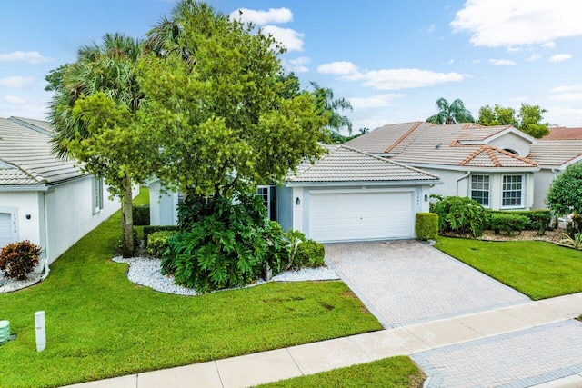 view of front of property featuring a garage and a front lawn