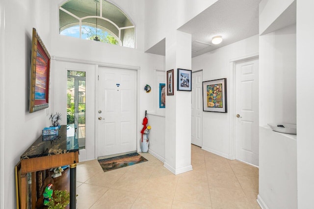 tiled entrance foyer featuring a textured ceiling