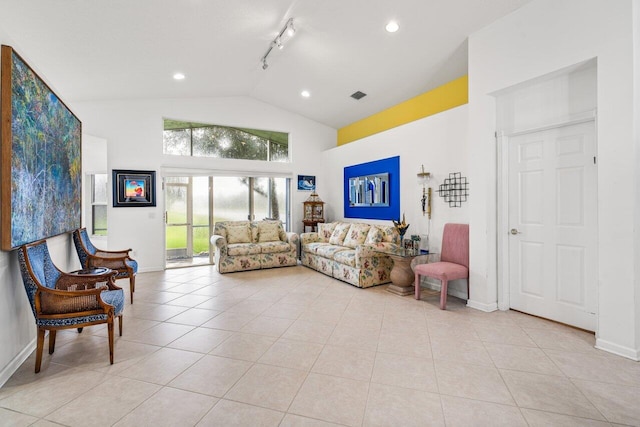 tiled living room featuring a wealth of natural light, rail lighting, and high vaulted ceiling