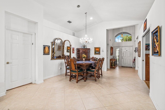 tiled dining area featuring high vaulted ceiling and a chandelier