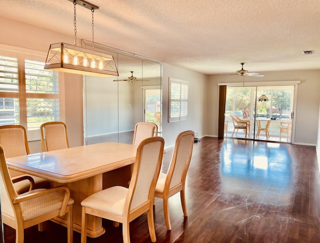 dining space featuring ceiling fan and a textured ceiling