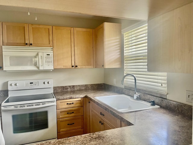 kitchen featuring sink, white appliances, and light brown cabinets