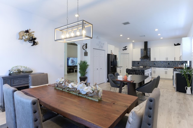 dining space with recessed lighting, visible vents, and light wood-type flooring