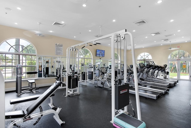 workout area featuring recessed lighting, visible vents, and plenty of natural light