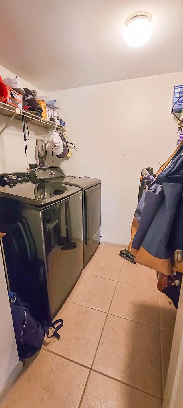 washroom with separate washer and dryer and tile patterned floors