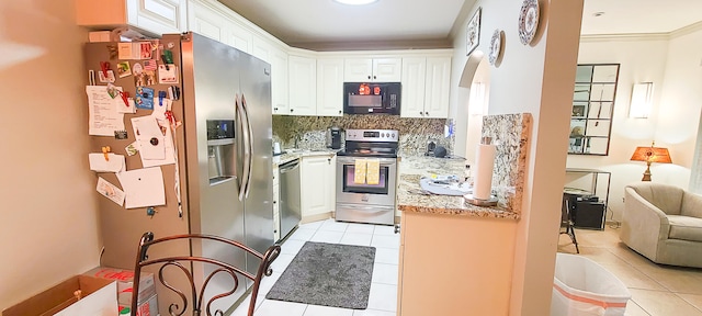 kitchen featuring light stone countertops, tasteful backsplash, stainless steel appliances, white cabinetry, and light tile patterned flooring