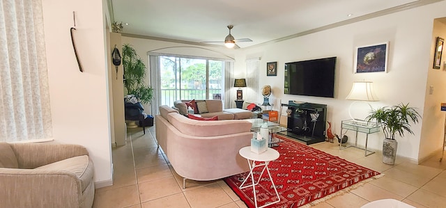 living room with ceiling fan, ornamental molding, and light tile patterned flooring