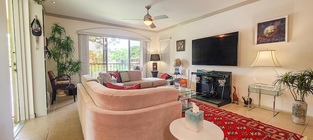 living room with light tile patterned floors, baseboards, ornamental molding, and a ceiling fan