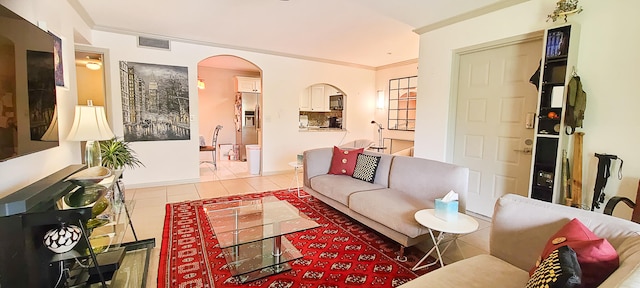 living room featuring light tile patterned floors and ornamental molding