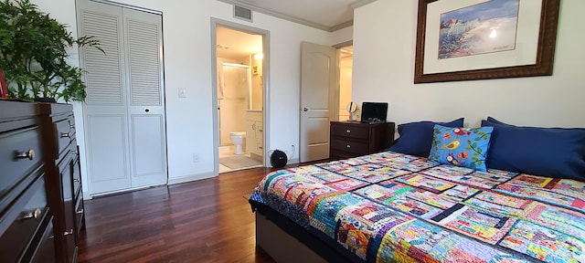 bedroom with dark wood-style floors, ensuite bathroom, visible vents, and crown molding