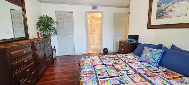 bedroom with dark wood-type flooring, a closet, connected bathroom, and crown molding