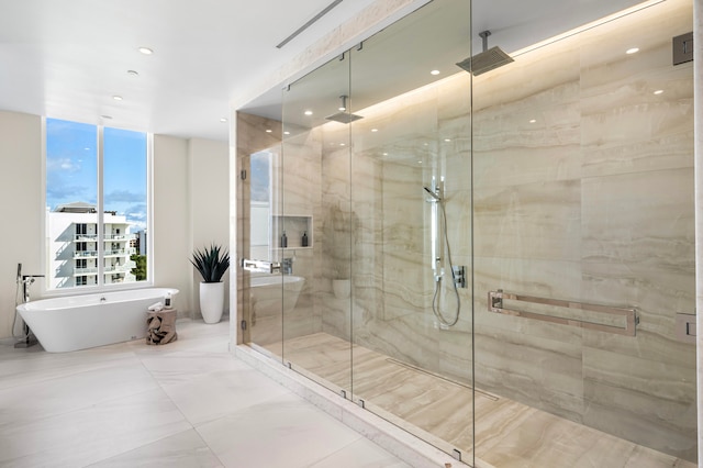 bathroom featuring shower with separate bathtub