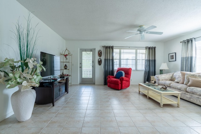 tiled living room with a textured ceiling and ceiling fan