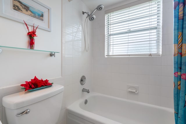 bathroom featuring shower / bath combo with shower curtain and toilet