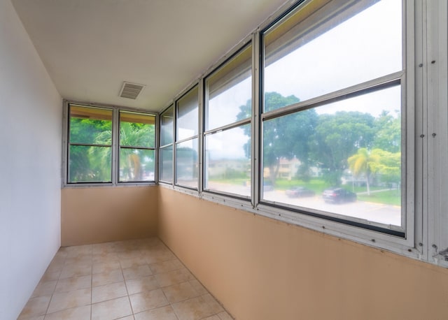 unfurnished sunroom featuring a wealth of natural light