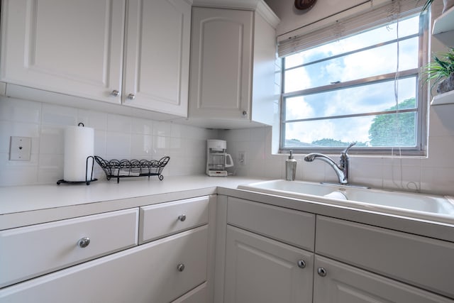 kitchen with white cabinetry, a wealth of natural light, and sink