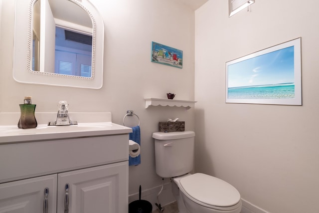 bathroom featuring toilet and vanity