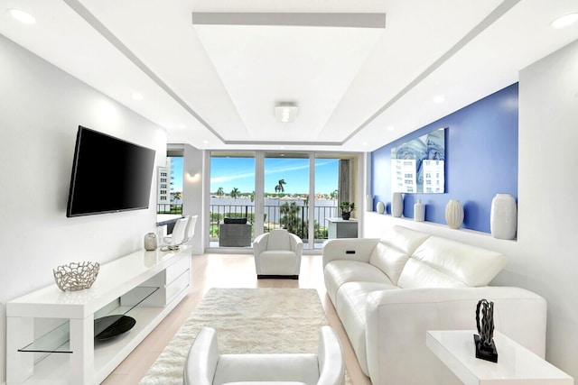 living room featuring expansive windows and light wood-type flooring