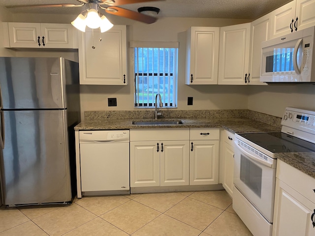 kitchen with white cabinetry, white appliances, sink, ceiling fan, and light tile patterned flooring