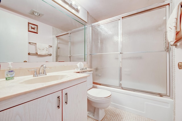 full bathroom with tile patterned floors, vanity, enclosed tub / shower combo, and toilet