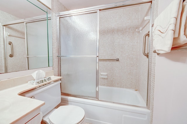 full bathroom with vanity, toilet, and bath / shower combo with glass door