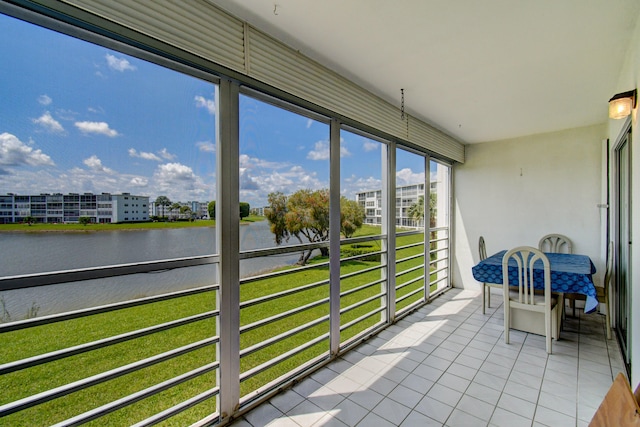 unfurnished sunroom featuring a water view