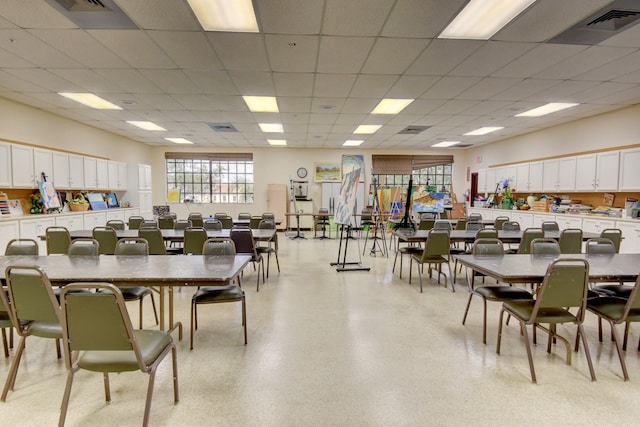 dining area with a drop ceiling