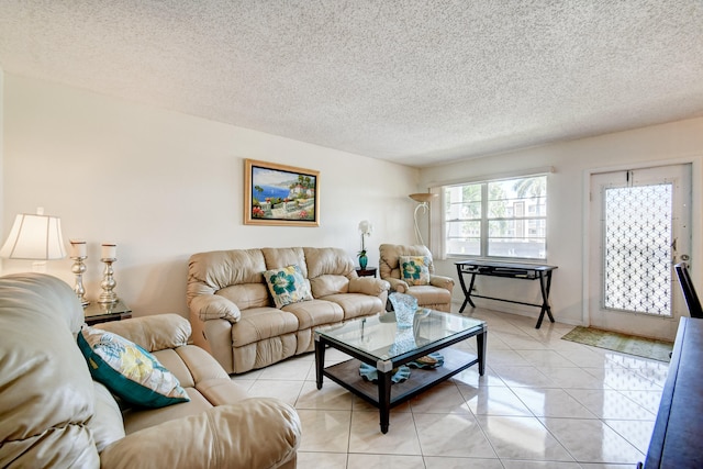 tiled living room featuring a textured ceiling