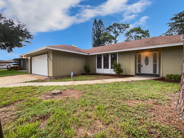 single story home featuring a garage and a front yard