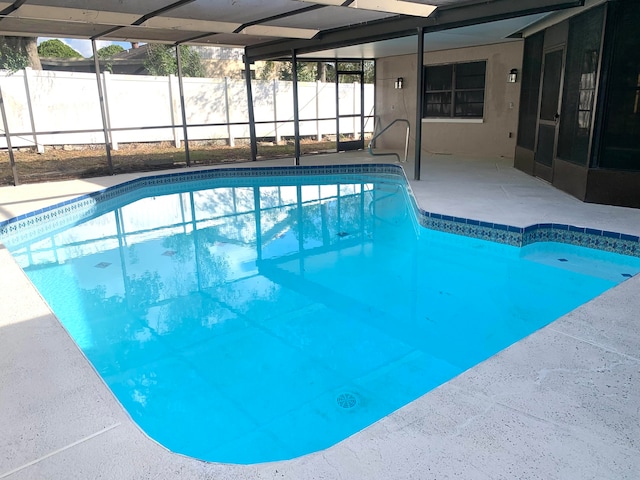 view of swimming pool with a lanai and a patio area