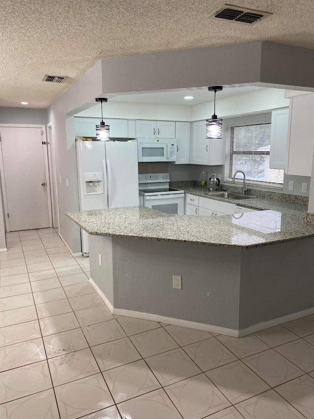 kitchen with pendant lighting, white appliances, kitchen peninsula, and white cabinetry