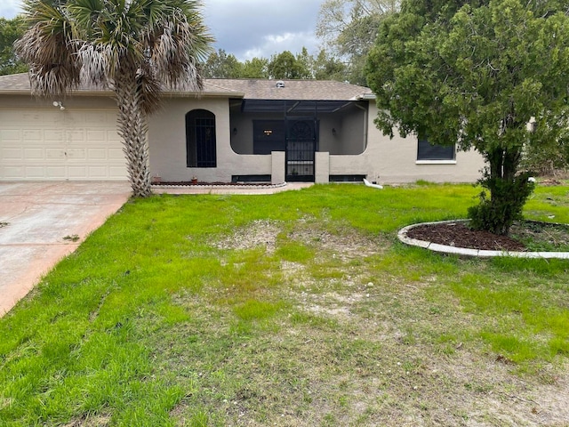 view of front of house with a front yard and a garage