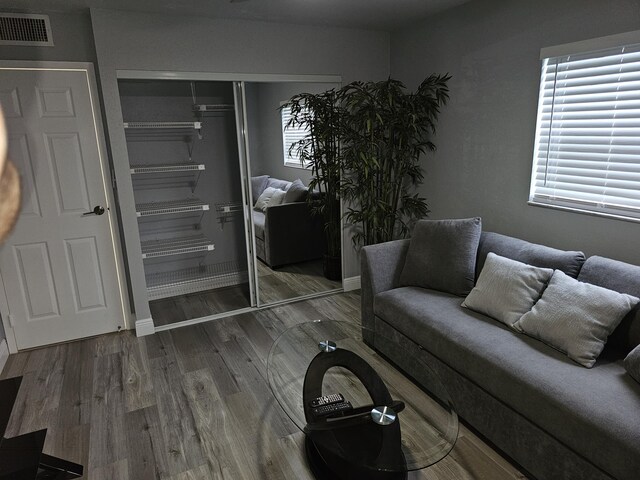 living area with wood finished floors and visible vents