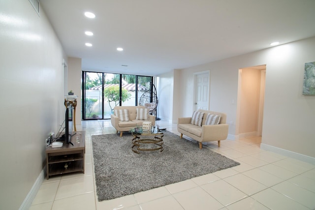 tiled living room featuring a wall of windows