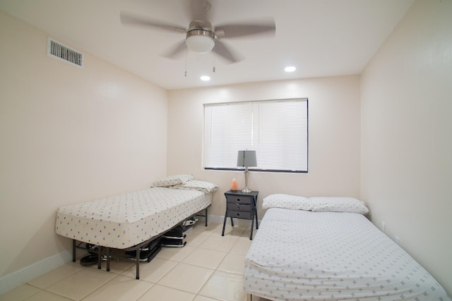 bedroom with ceiling fan and light tile patterned flooring