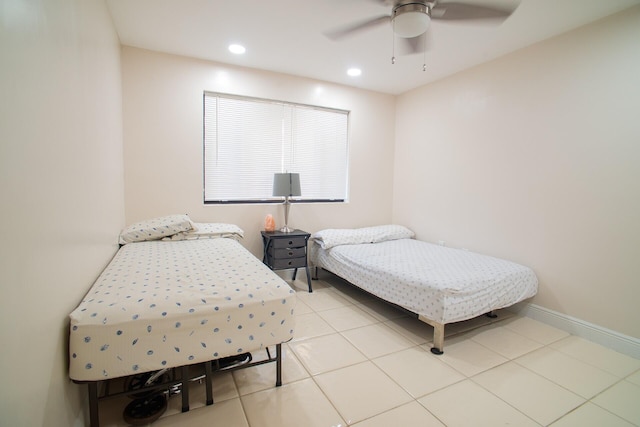 bedroom with ceiling fan and light tile patterned floors