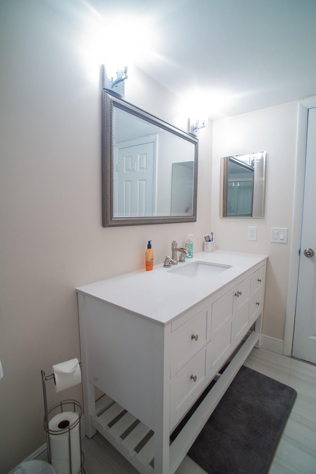 bathroom with hardwood / wood-style floors and vanity