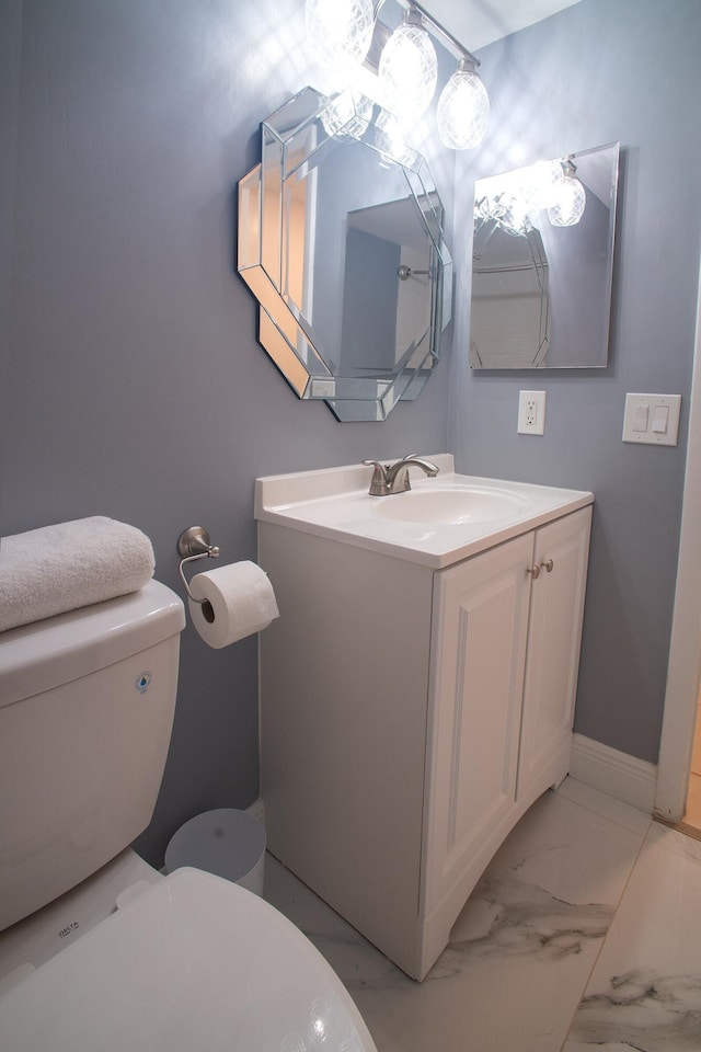 bathroom featuring vanity and toilet