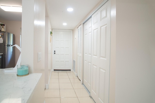 kitchen featuring light tile patterned floors and stainless steel fridge