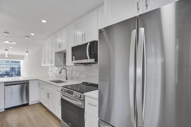 kitchen featuring sink, backsplash, white cabinetry, dishwasher, and light stone countertops