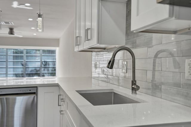 kitchen featuring light hardwood / wood-style floors, sink, white cabinetry, hanging light fixtures, and appliances with stainless steel finishes