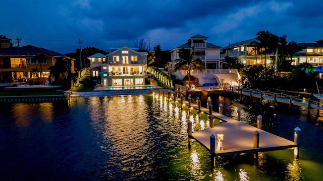 view of dock with a water view and a balcony