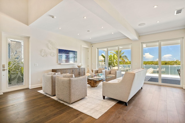 living room featuring beamed ceiling and dark hardwood / wood-style floors