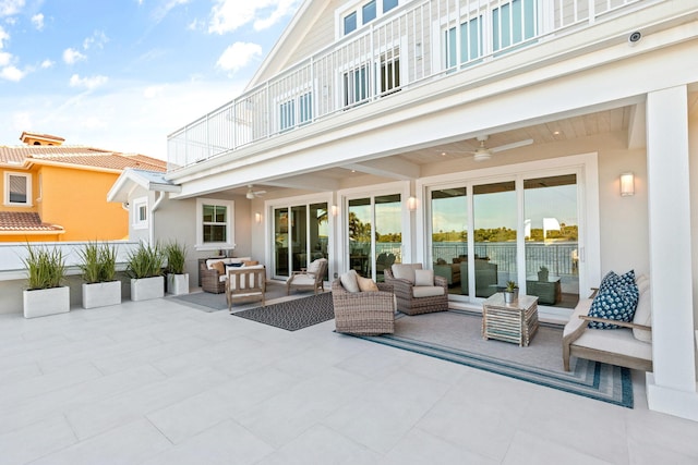 back of property featuring a balcony, ceiling fan, a patio, and outdoor lounge area