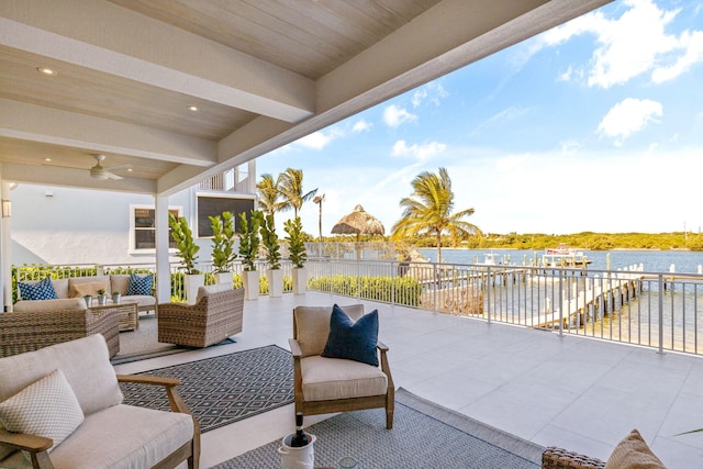 view of patio / terrace with an outdoor living space, ceiling fan, and a water view