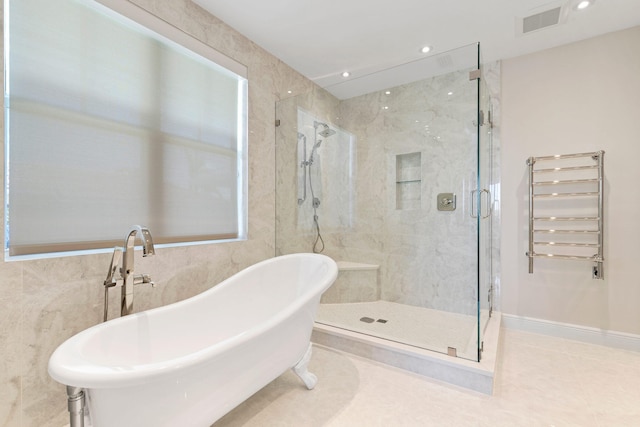 bathroom with separate shower and tub, radiator heating unit, and tile patterned floors