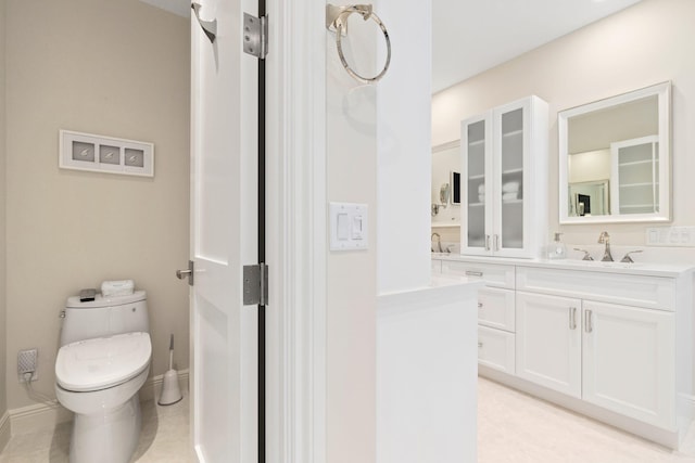 bathroom with tile patterned flooring, vanity, and toilet