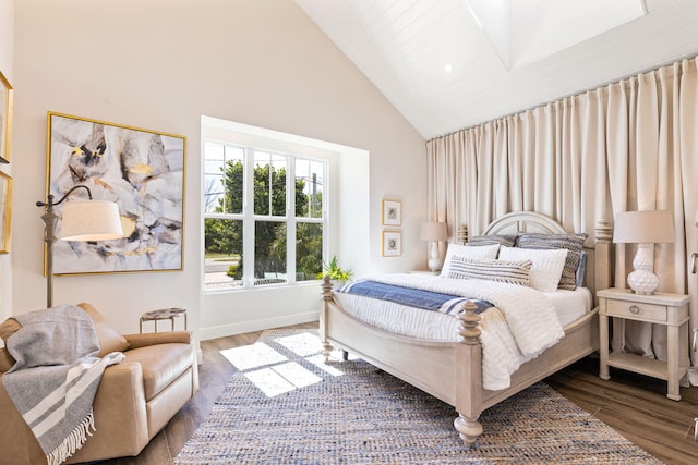 bedroom featuring hardwood / wood-style floors and high vaulted ceiling