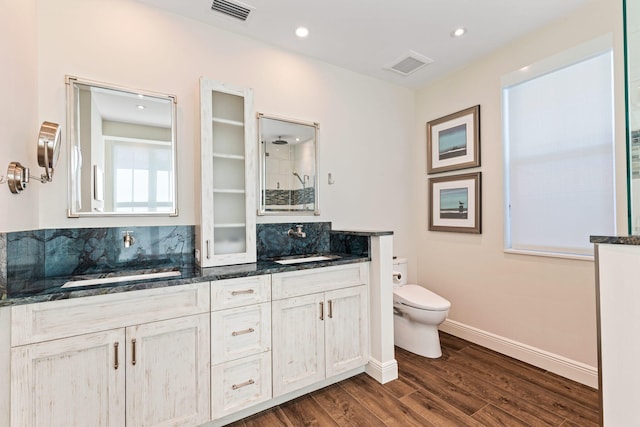 bathroom featuring wood-type flooring, toilet, and vanity